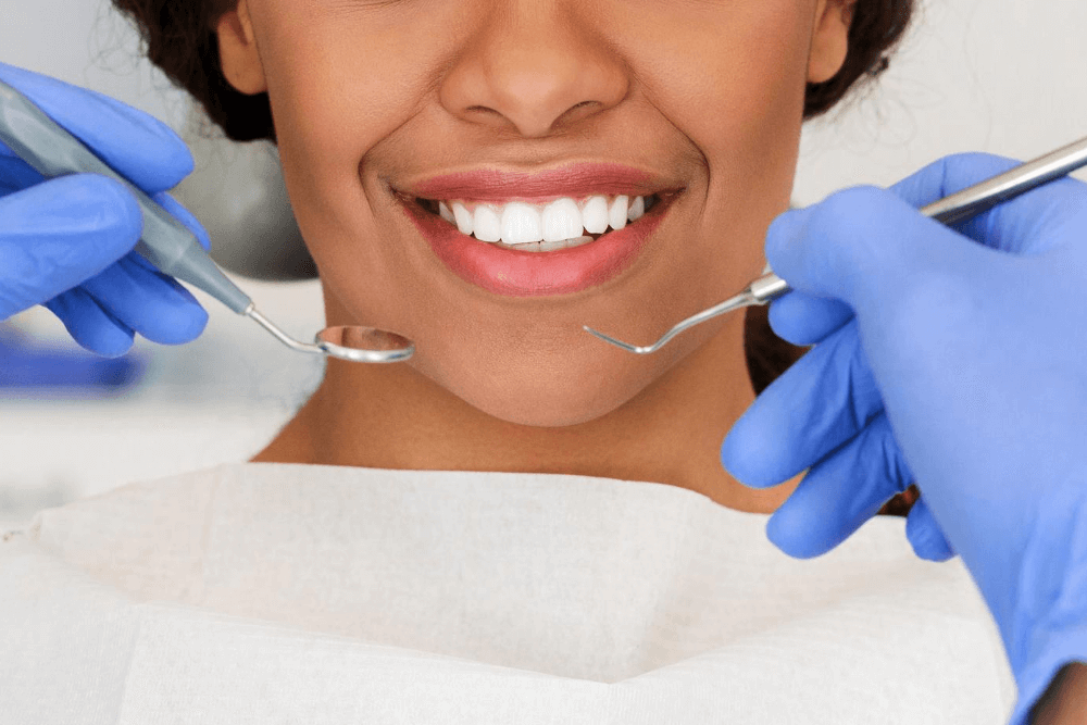 women with perfect teeth sitting in a dentists chair
